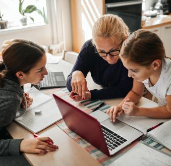 Parent and children working on computer