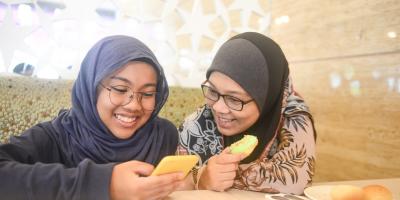 Students looking at cell phone