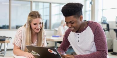 Students looking at laptop