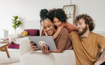 Happy family using a device together